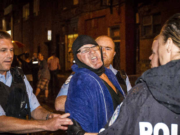 A man is arrested by police outside the Parti Quebecois victory rally in Montreal on Wednesday, Sept. 5, 2012.