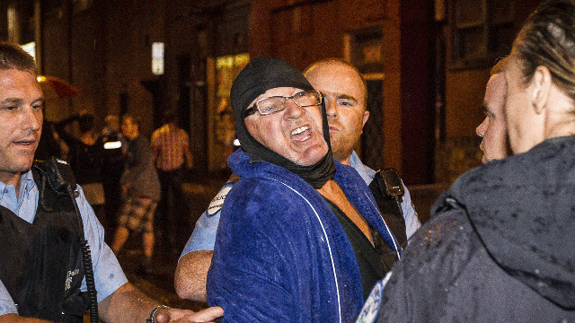 A man is arrested by police outside the Parti Quebecois victory rally in Montreal on Wednesday, Sept. 5, 2012.  