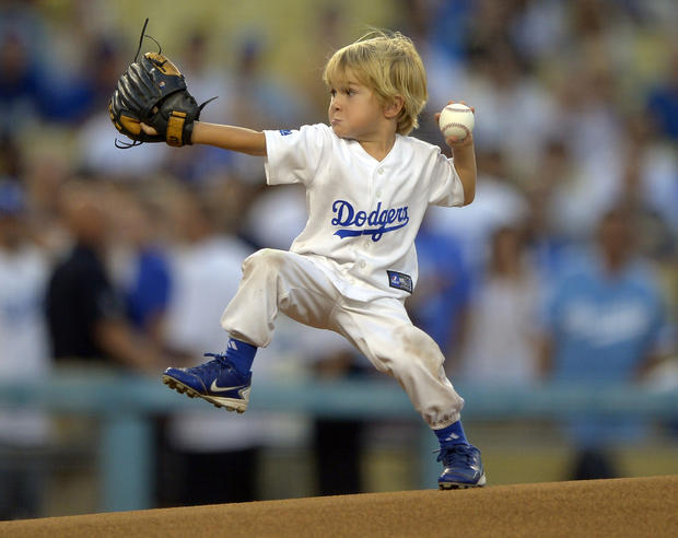 Three-year-old actor Christian Haupt throws out the ceremonial first pitch  