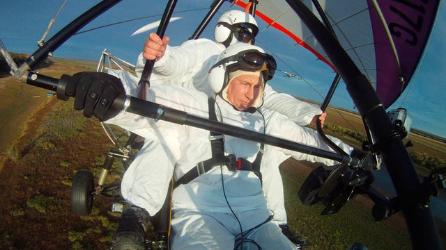 Russian President Vladimir Putin, flies in a motorized hang glider 
