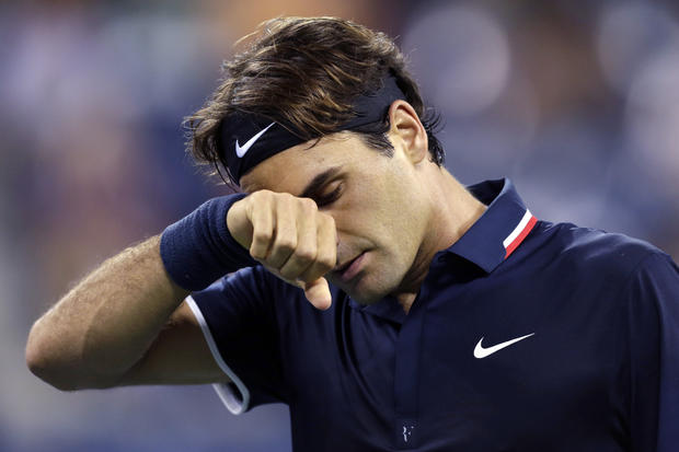 Roger Federer wipes his brow late in the fourth set during his loss to Tomas Berdych 