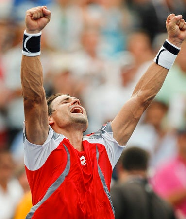 David Ferrer of Spain reacts after defeating Janko Tipsarevic 