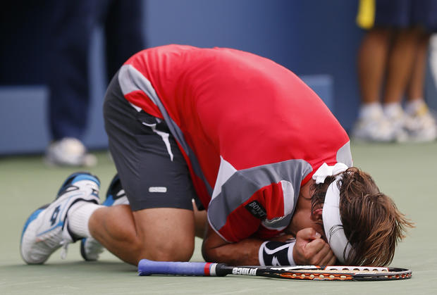 David Ferrer reacts after defeating Janko Tipsarevic 