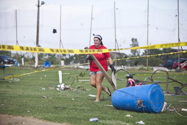 Lifeguard cleans up debris from a tornado that touched down on September 8, 2012 in the Breezy Point neighborhood of the Queens borough of New York City. The National Weather Service has issued a tornado watch as severe weather continues to move through N 