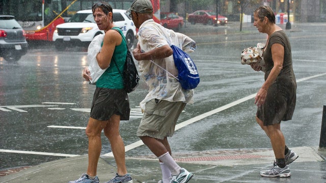 People brave the weather during a heavy rainstorm in Washington on September 8, 2012. Severe thunderstorms hit the region and a tornado hit Fairfax County in nearby Virginia but no damage or casualties were reported, according to local media. 