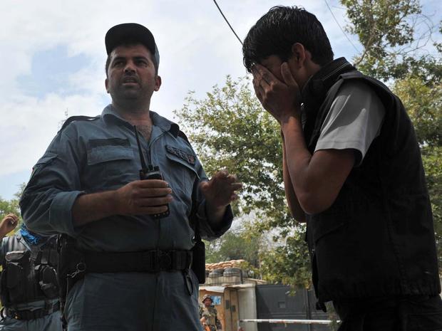 An Afghan man cries at the site of a suicide attack outside NATO headquarters in Kabul 