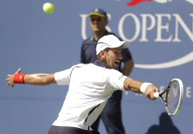 Novak Djokovic returns a shot to Spain's David Ferrer 