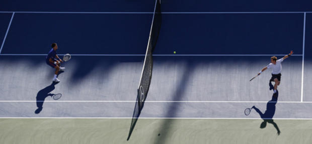 Andy Murray returns a shot to Novak Djokovic  
