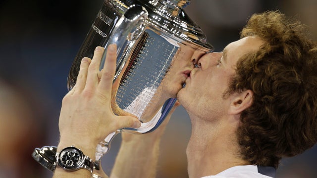 Andy Murray poses with the trophy after beating Novak Djokovic 