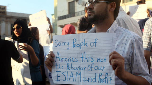 A Libyan man holds a placard in English Sept. 12, 2012, during a demonstration against the attack on the U.S. Consulate that killed four Americans, including the U.S. ambassador, in Benghazi, Libya. 