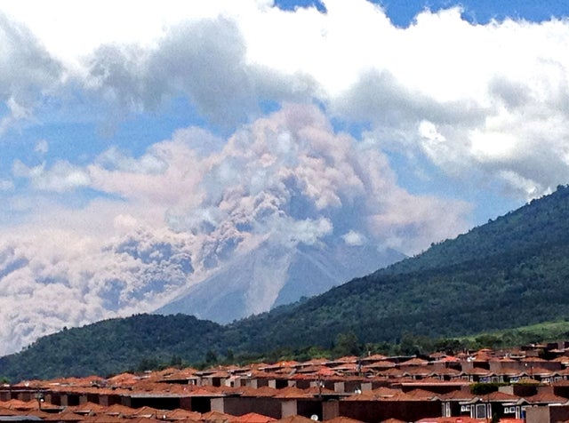 In this image captured on cell phone, plumes of smoke rise from the Volcan de Fuego or Volcano of Fire spews ash seen from Palin, south of Guatemala City, Thursday, Sept. 13, 2012.  