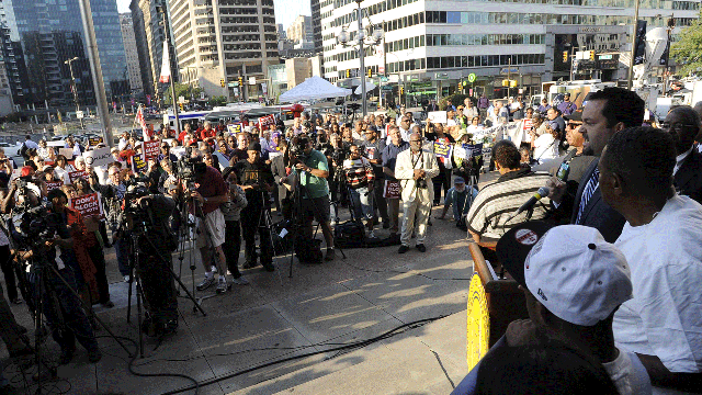 President of the NAACP, Benjamin Todd Jealous, right, speaks to a crowd during the NAACP voter ID rally to demonstrate the opposition of Pennsylvania's new voter identification law, Sept. 13, 2012.  