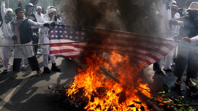 Muslim protesters burn a U.S. flag during a protest against the American-made film "Innocence of Muslims" outside the U.S. Embassy in Jakarta, Indonesia, Sept. 17, 2012. 
