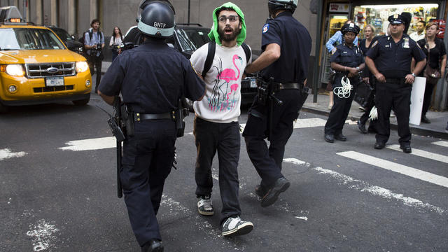 Occupy Wall Street protestor is arrested on Wall Street for blocking pedestrian traffic Monday 