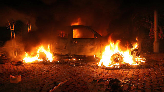 A vehicle burns after an attack by gunmen on the U.S. diplomatic office in Benghazi 