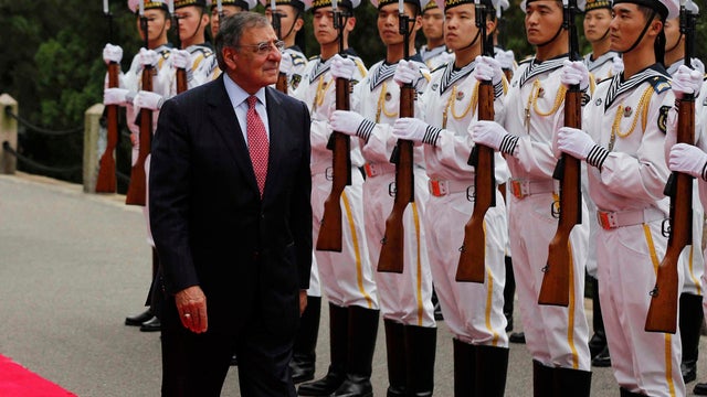 U.S. Defense Secretary Leon Panetta reviews a naval honor guard at Qingdao 