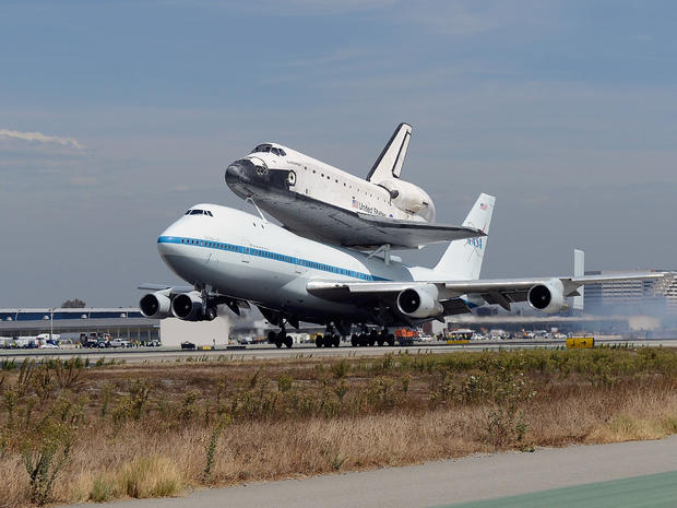 LOS ANGELES, CA - SEPTEMBER 21: Space shuttle Endeavour, sitting on top of NASA's Shuttle Carrier Aircraft or SCA, lands at Los Angeles International Airport on September 21, 2012 in Los Angeles, California. The Space Shuttle Endeavour will be placed on p 