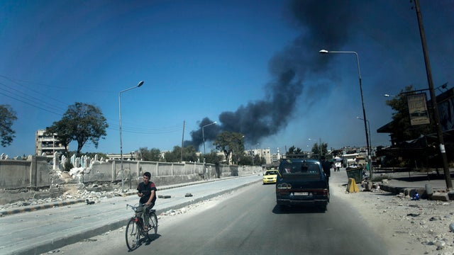 Black smoke rises from a government shelling in a residential area in Aleppo, Syria, in this Sunday, Sept. 23, 2012 photo. 