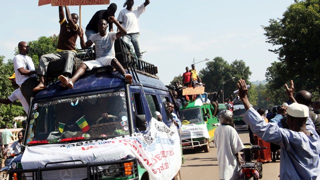 People holding banners sit on a truck Sept. 28, 2012, during a protest called by the Coordination of Patriotic Organizations in Mali against a foreign military intervention to reclaim the Islamist-controlled north. 