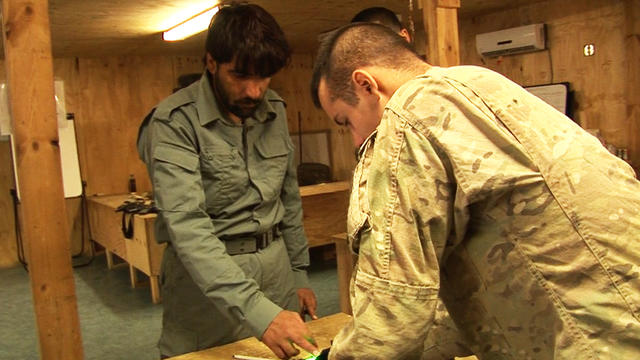 U.S. soldier registers details of an Afghan troop 