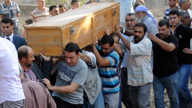 People carry Oct. 4, 2012, the coffin of one of the five Turkish civilians who were killed Oct. 3, 2012, by a mortar bomb in the southern border town of Akcakale, Turkey. 