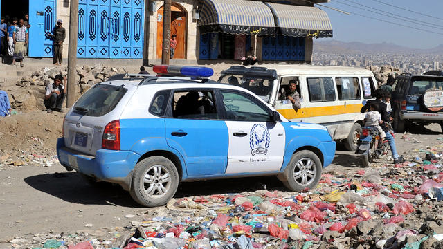 A Yemeni police car is parked at the scene where unidentified gunmen shot dead a senior Yemeni security official, Qassem Aqlani, employed by the U.S. Embassy in Sanaa, in a hit-and-run attack Oct. 11, 2012. 