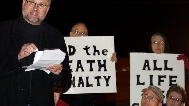 Reynold Nesiba, a death-penalty opponent, speaks to a crowd of protesters outside the South Dakota Penitentiary in Sioux Falls, S.D., on Monday, Oct. 15, 2012, in anticipation of the execution of Eric Robert. Robert pleaded guilty in the April 12, 2011, s 