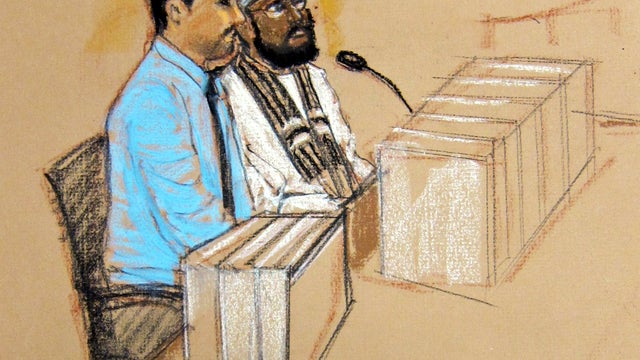Mustafa Ahmad al-Hawsawi, right, one of the five Guantanamo prisoners charged in the Sept. 11 attacks, sits at a defense table with his court translator during a military tribunal pretrial hearing at the Guantanamo Bay Naval Base in Cuba, Oct. 15, 2012, i 
