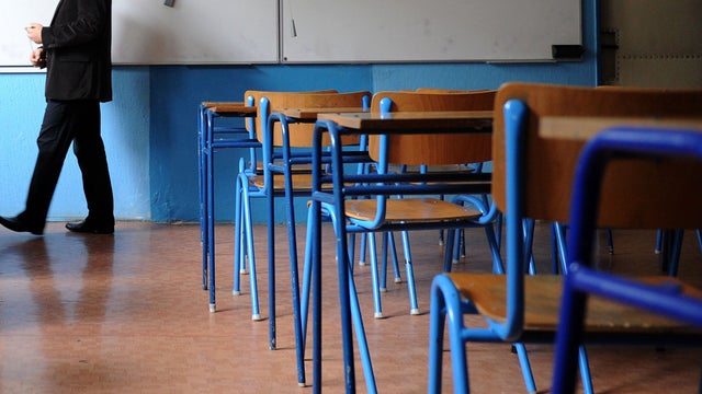 A school teacher paces on September 13, 2012, in a classroom. 