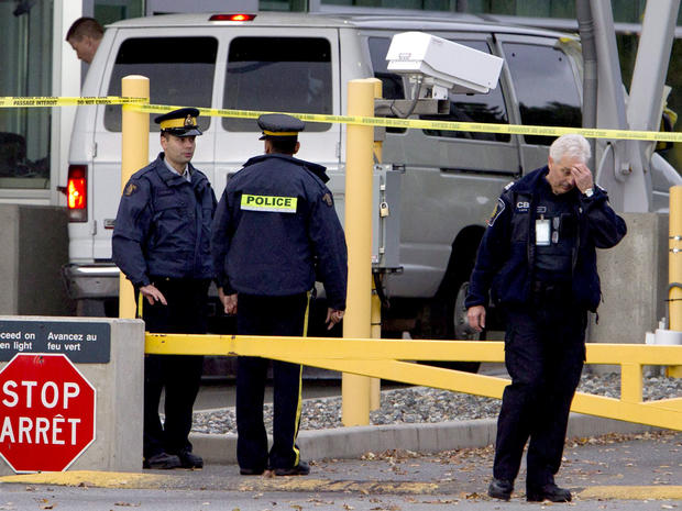 Police investigate a van at the scene of a shooting at the Blaine, Wash./Surrey, British Columbia border crossing Tuesday, Oct. 16, 2012. 