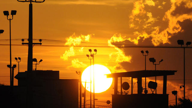 Towers overlooking a U.S. detention facility are silhouetted against a morning sunrise at Guantanamo Bay Naval Base in Cuba Oct. 18, 2012, in this picture reviewed by the U.S. Department of Defense. 