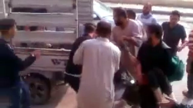 Syrians help an injured man onto a truck after a shelling in Aleppo, Syria, Oct. 23, 2012, in this video footage on YouTube that could not be independently verified. 