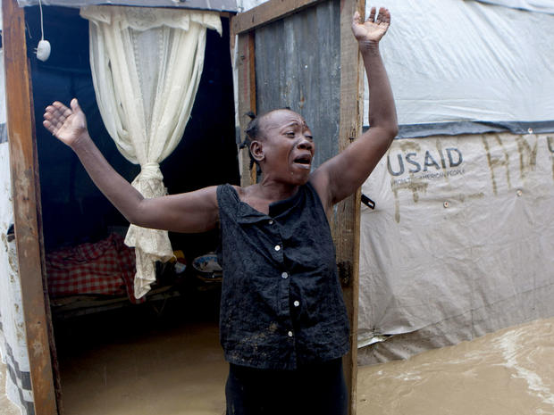 A woman cries out in front of her flooded house caused by heavy rains from Hurricane Sandy in Port-au-Prince, Haiti, Thursday, Oct. 25, 2012. Hurricane Sandy rumbled across mountainous eastern Cuba and headed toward the Bahamas on Thursday as a Category 2 