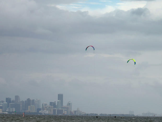Santiago Porteiro (R) and others take advantage of the winds from the outerbands of Hurricane Sandy to kite surf on October 24, 2012 in Miami, Florida.  
