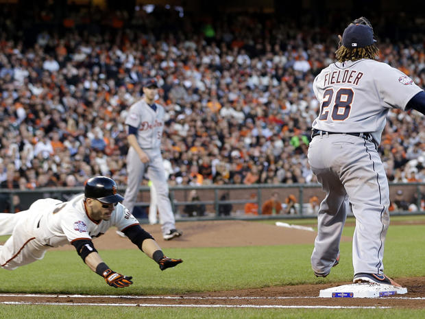 San Francisco Giants' Marco Scutaro dives into first as Detroit Tigers first baseman Prince Fielder (28) takes the throw to force him out during the third inning of Game 2 of the World Series Oct. 25, 2012, in San Francisco. 