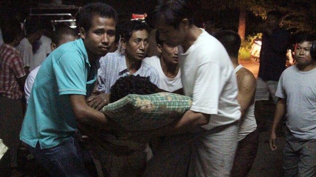 An injured Rakhine refugee is carried into Kyauktaw hospital 