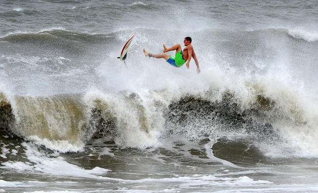 A surfer kicks out at the top of a wave after a ride, in Jacksonville, Fla. 