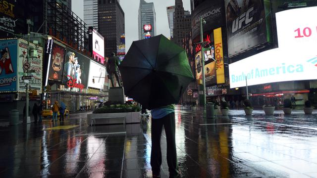 A lone tourist stands in Times Square early October 29, 2012 as New Yorkers prepare for Hurricane Sandy  