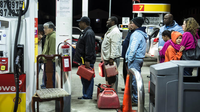 People wait in line to fill containers with fuel at a Shell gas station Oct. 30, 2012, in Edison, N.J. 