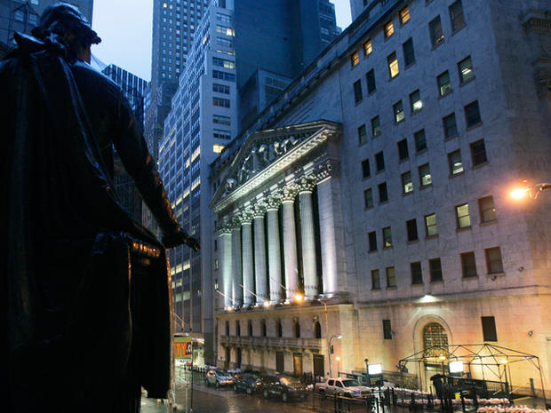 The statue of George Washington at Federal Hall watches over the New York Stock Exchange on October 29, 2012, as superstorm Sandy sweeps Wall Street. 
