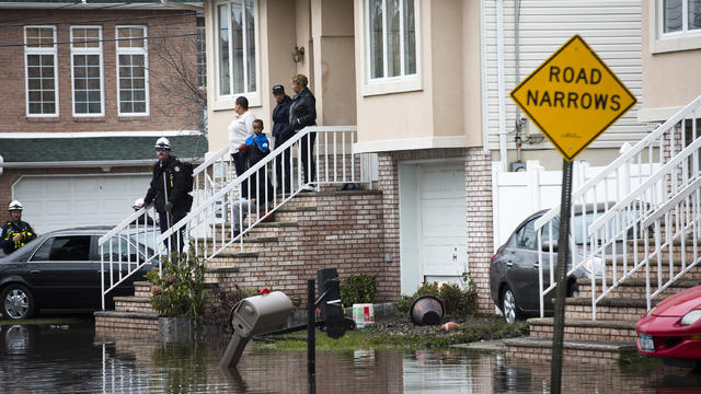 Rescue workers check a home for fuel leaks and other types of damage, Wednesday, Oct. 31, 2012, in the Staten Island borough of New York. 