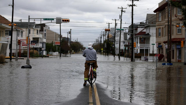 Man surveys Ocean City, N.J. street flooded by superstorm Sandy, on Oct. 30, 2012 