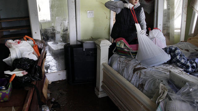 Brooke Clarkin tries to salvage some personal items from her mother's home in Staten Island, N.Y., Nov. 1, 2012. 