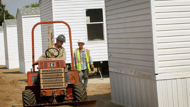 Workers build a mobile home community for FEMA homes near the airport in Joplin, Mo., July 29, 2011. 