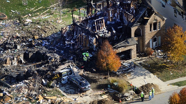 Citizens Energy workers continue their investigation Nov. 12, 2012, at the site of an explosion at a house in Indianapolis. 