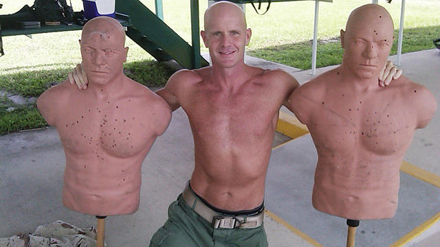 Undated photograph obtained by The Seattle Times shows FBI Special Agent Frederick Humphries posing with target dummies 