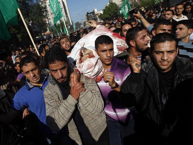 Palestinians carry the body of Ahmad Jabari at his funeral in Gaza 