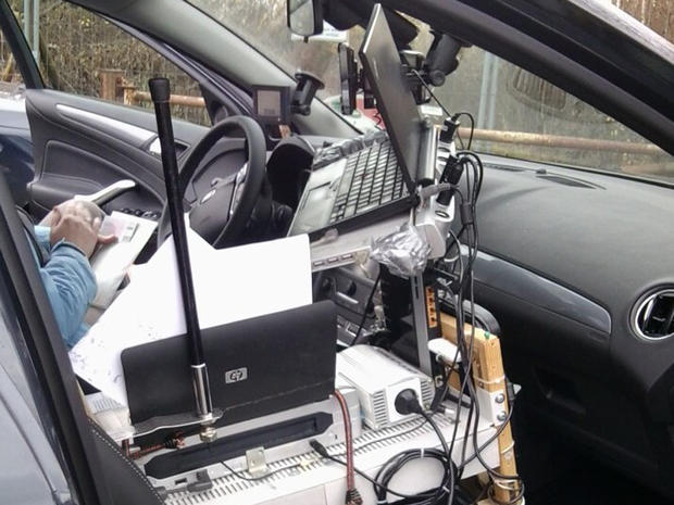 A vehicle with its interior wired up like a mobile office stopped on the autobahn. 