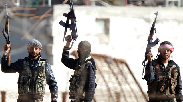Syrian opposition fighters celebrating on the strategic Syrian border town of Ras al-Ain 