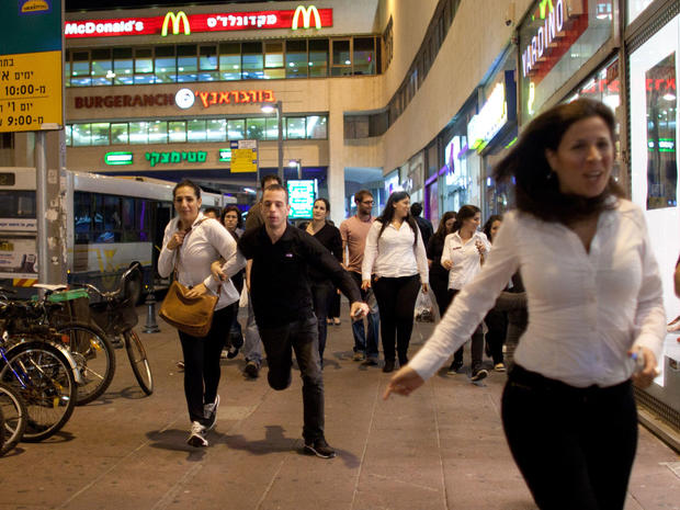 Israelis run for cover during a rocket attack on November 18, 2012 in Tel Aviv, Israel. 